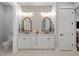 Stylish bathroom featuring double sinks, ornate mirrors, and modern fixtures at 7912 Raphael Ln, Littleton, CO 80125
