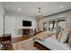 Beautiful bedroom featuring hardwood floors, a chandelier, and sliding glass doors to a balcony at 7912 Raphael Ln, Littleton, CO 80125