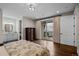 Comfortable bedroom with a walk-out balcony, elegant bathroom access and an antique chest at 7912 Raphael Ln, Littleton, CO 80125