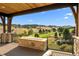 Covered outdoor deck with stone fire pit and golf course views at 7912 Raphael Ln, Littleton, CO 80125