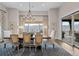 Open dining area features a large window with scenic views, an elegant chandelier and wood floors at 7912 Raphael Ln, Littleton, CO 80125