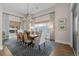Dining room boasts a large window with view, and elegant chandelier above table with seating at 7912 Raphael Ln, Littleton, CO 80125