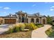 Beautiful two-story home with stone accents, mature landscaping, and a welcoming walkway at 7912 Raphael Ln, Littleton, CO 80125