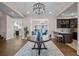 Elegant foyer with hardwood floors, designer chandelier, and open sightlines to the kitchen and living areas at 7912 Raphael Ln, Littleton, CO 80125