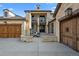 Impressive front entry with an open-air courtyard, stone columns and a cozy fireplace at 7912 Raphael Ln, Littleton, CO 80125