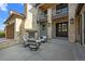 Inviting outdoor patio featuring a stone fireplace, comfortable seating and an elegant entrance at 7912 Raphael Ln, Littleton, CO 80125