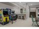 Spacious game room featuring classic arcade games, seating at the bar, and stairway access at 7912 Raphael Ln, Littleton, CO 80125
