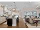 Open kitchen flows into the living room with view, features a large island and wood floors at 7912 Raphael Ln, Littleton, CO 80125