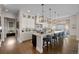 Gourmet kitchen with large island, white cabinetry, pendant lighting, and stainless appliances at 7912 Raphael Ln, Littleton, CO 80125