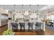 Gourmet kitchen features island seating, pendant lights and white cabinets at 7912 Raphael Ln, Littleton, CO 80125