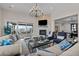 Elegant living room featuring a stone fireplace, stylish chandelier, and comfortable seating at 7912 Raphael Ln, Littleton, CO 80125