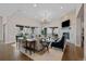 Bright and spacious living room with a stone fireplace, large windows, and comfortable seating at 7912 Raphael Ln, Littleton, CO 80125