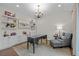Well-lit home office with custom built-ins, shelving, and modern decor at 7912 Raphael Ln, Littleton, CO 80125