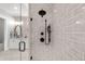 Contemporary bathroom shower with sleek gray tile and modern fixtures, next to vanity at 7912 Raphael Ln, Littleton, CO 80125