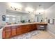 Double vanity bathroom with a large mirror and plenty of counter space at 5562 Rim View Pl, Parker, CO 80134