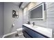 Modern powder room with wave patterned tile and floating vanity at 5562 Rim View Pl, Parker, CO 80134