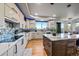 Modern kitchen with white and wood cabinets, marble island and stainless steel appliances at 5562 Rim View Pl, Parker, CO 80134