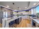 Modern kitchen with white cabinets, marble island and stainless steel appliances at 5562 Rim View Pl, Parker, CO 80134