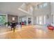 Two story living room with hardwood floors, fireplace and piano at 5562 Rim View Pl, Parker, CO 80134