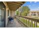 Cozy covered balcony with seating, offering views of the well-maintained landscaping at 8225 Fairmount Dr # 106, Denver, CO 80247