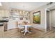 Cozy dining area featuring a round table, chairs, a decorative chandelier, and built-in shelving for ample storage at 8225 Fairmount Dr # 106, Denver, CO 80247