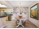 Charming dining area complemented by built-in shelving, stylish chandelier, and an adjacent, updated kitchen at 8225 Fairmount Dr # 106, Denver, CO 80247