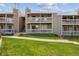 Exterior view of a building with two-story apartments and well-kept green lawns at 8225 Fairmount Dr # 106, Denver, CO 80247