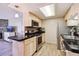 Well-equipped kitchen with stainless steel appliances, sleek black countertops, and light wood cabinetry at 8225 Fairmount Dr # 106, Denver, CO 80247