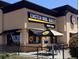 Exterior of Einstein Bros. Bagels with drive-thru, patio seating and breakfast, lunch and catering options at 8225 Fairmount Dr # 106, Denver, CO 80247