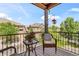Outdoor seating balcony provides a cozy space to relax with neighborhood views and blue sky backdrop at 10064 Bluffmont Ct, Lone Tree, CO 80124