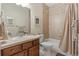 Full bathroom featuring a shower-tub combo, neutral tile and finishes, and a vanity sink at 10064 Bluffmont Ct, Lone Tree, CO 80124