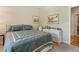 Bedroom featuring neutral walls, framed pictures, a double bed and a white dresser at 10064 Bluffmont Ct, Lone Tree, CO 80124
