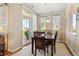Comfortable dining area near a sliding glass door with an elegant chandelier and views of the surroundings at 10064 Bluffmont Ct, Lone Tree, CO 80124