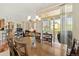 Elegant dining room area with a large table, chandelier, and access to the outdoor balcony, perfect for entertaining at 10064 Bluffmont Ct, Lone Tree, CO 80124