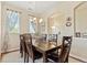 Chic dining room with a traditional table set, chandelier, and natural light coming from the large windows at 10064 Bluffmont Ct, Lone Tree, CO 80124