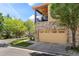 Attached two-car garage with balcony above on a townhome featuring low-maintenance landscaping and easy access at 10064 Bluffmont Ct, Lone Tree, CO 80124