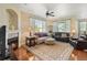 Inviting living room with a fireplace, hardwood floors, and plush seating arrangement for comfortable living at 10064 Bluffmont Ct, Lone Tree, CO 80124