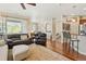 Bright living room with hardwood floors, large window, and comfortable seating arrangement create an inviting space at 10064 Bluffmont Ct, Lone Tree, CO 80124