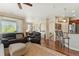 Spacious living room with hardwood floors, large window, and comfortable seating offers ample natural light at 10064 Bluffmont Ct, Lone Tree, CO 80124