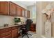 Well-lit office features custom wood cabinetry and desk space, ideal for a productive work environment at 10064 Bluffmont Ct, Lone Tree, CO 80124