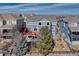 Aerial view of a residence showing the deck, fenced yard, mature trees, and the surrounding neighborhood at 15972 E Tall Timber Ln, Parker, CO 80134