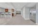 Spacious finished basement offers a seating area, bar with modern stools, and a stainless steel refrigerator at 15972 E Tall Timber Ln, Parker, CO 80134