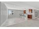 Finished basement featuring a bar with seating, granite countertop, tile floor and light gray painted walls at 15972 E Tall Timber Ln, Parker, CO 80134