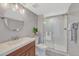 Modern bathroom with a glass shower, round mirror, and modern sink at 15972 E Tall Timber Ln, Parker, CO 80134