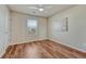 Bedroom with hardwood floors, a ceiling fan, and a sunlit window at 15972 E Tall Timber Ln, Parker, CO 80134