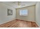 Bedroom with hardwood floors, ceiling fan, and view-filled window at 15972 E Tall Timber Ln, Parker, CO 80134