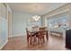 Bright dining room with wood floors, a chandelier, and large windows at 15972 E Tall Timber Ln, Parker, CO 80134