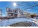 Attractive gray two-story home with covered porch and 2 car garage on a sunny day at 15972 E Tall Timber Ln, Parker, CO 80134