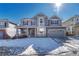 Two-story gray home with a welcoming front porch and attached two-car garage at 15972 E Tall Timber Ln, Parker, CO 80134