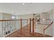 Second floor hallway with wood floors and decorative railing at 15972 E Tall Timber Ln, Parker, CO 80134